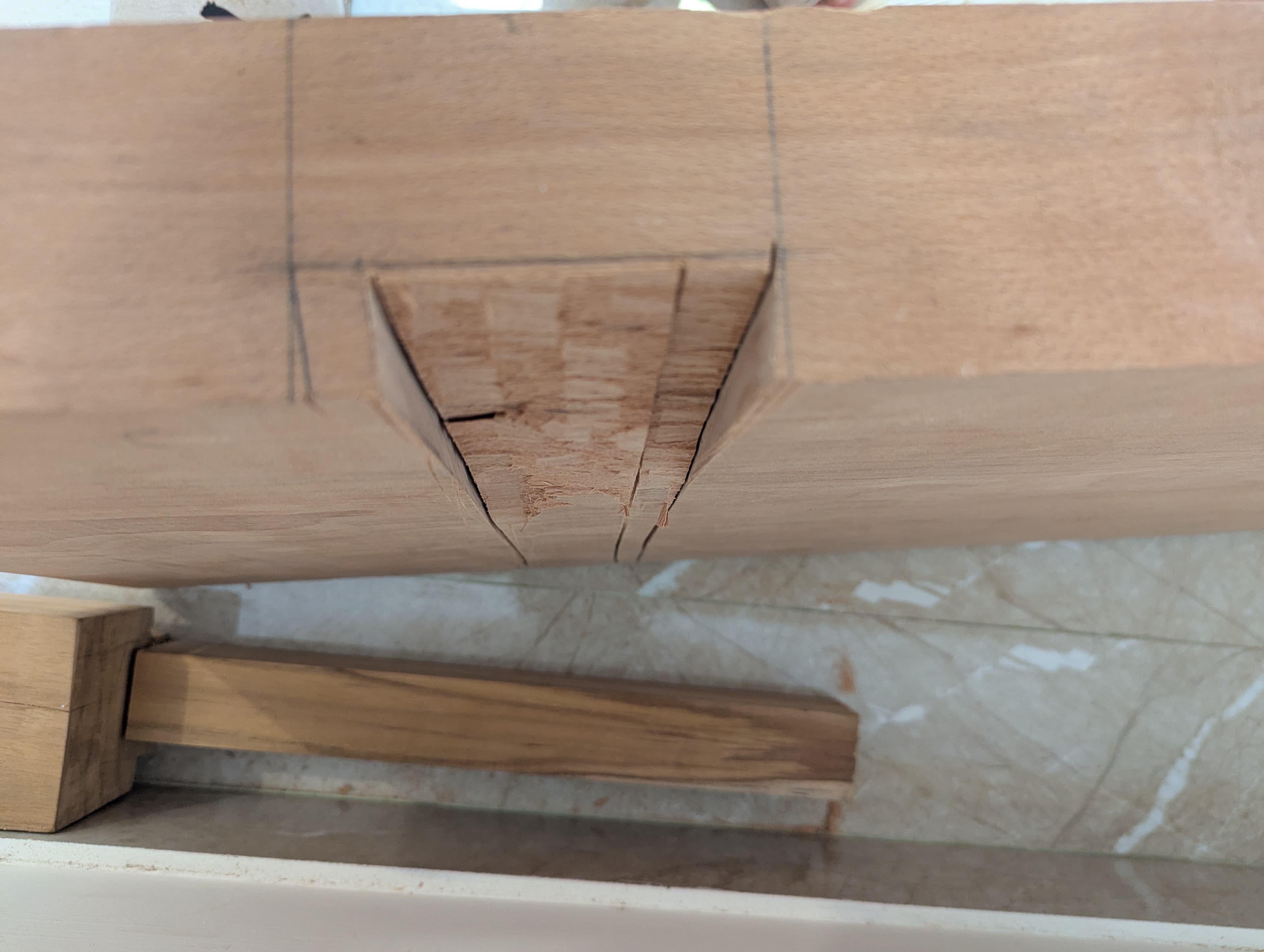 Chiseling out the tapered dovetail socket for a leg on the atedai body